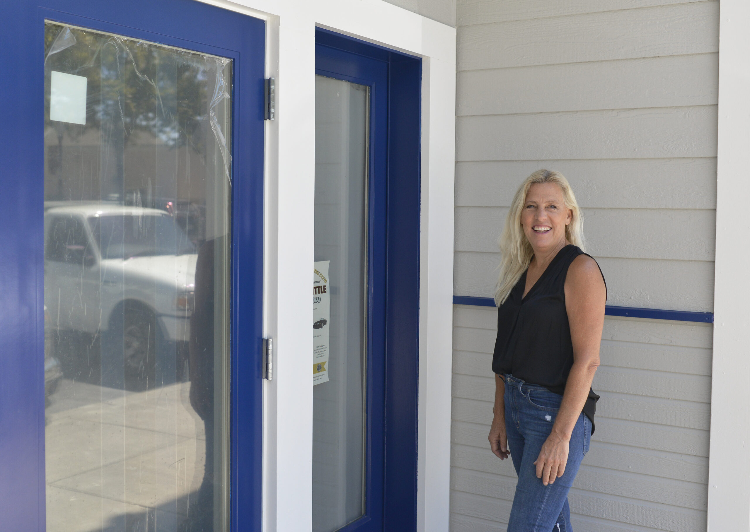 Restaurant owner Shelly Konstatigas posing infront of the restaurant doors.