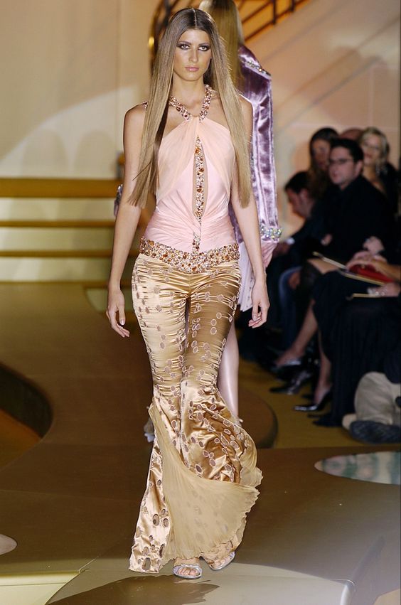 Bluemarine 2020 Runway look, model wears gold flare jeans 